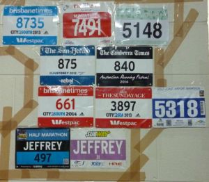 The bib wall of fame at home, with the newest addition (number 5318) alongside the pair of red and white bibs.